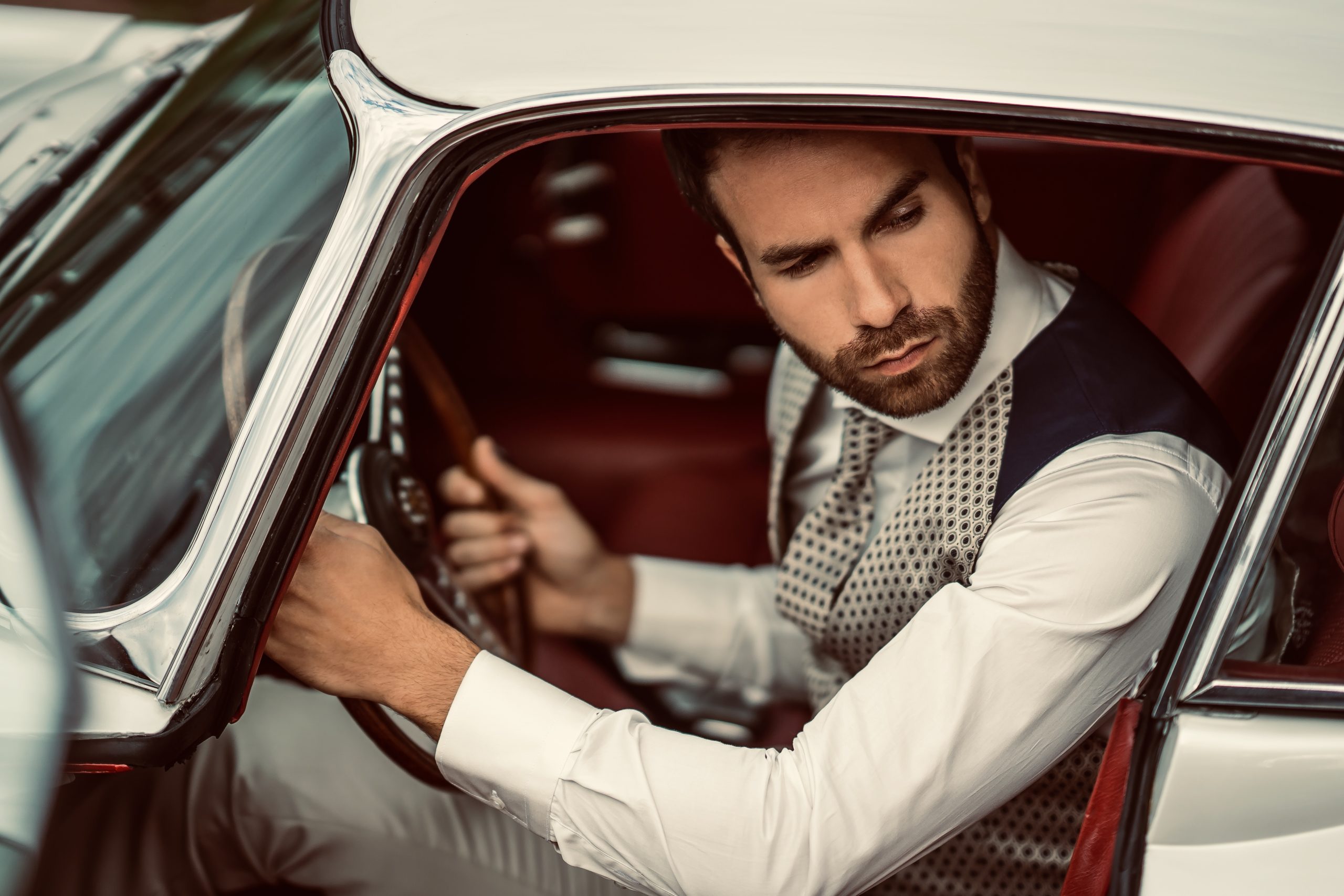 homme conduit voiture, gilet bleu et beige, costume de mariage, voiture de collection, costume de mariage, voiture collection jaguar, camilliano costumes, pantalon tailleur bleu